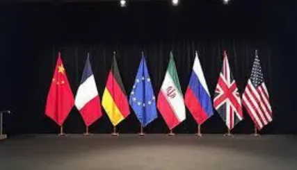 Eight national flags lined up on a dark stage: China, France, Germany, the European Union, Iran, Russia, the United Kingdom and the United States